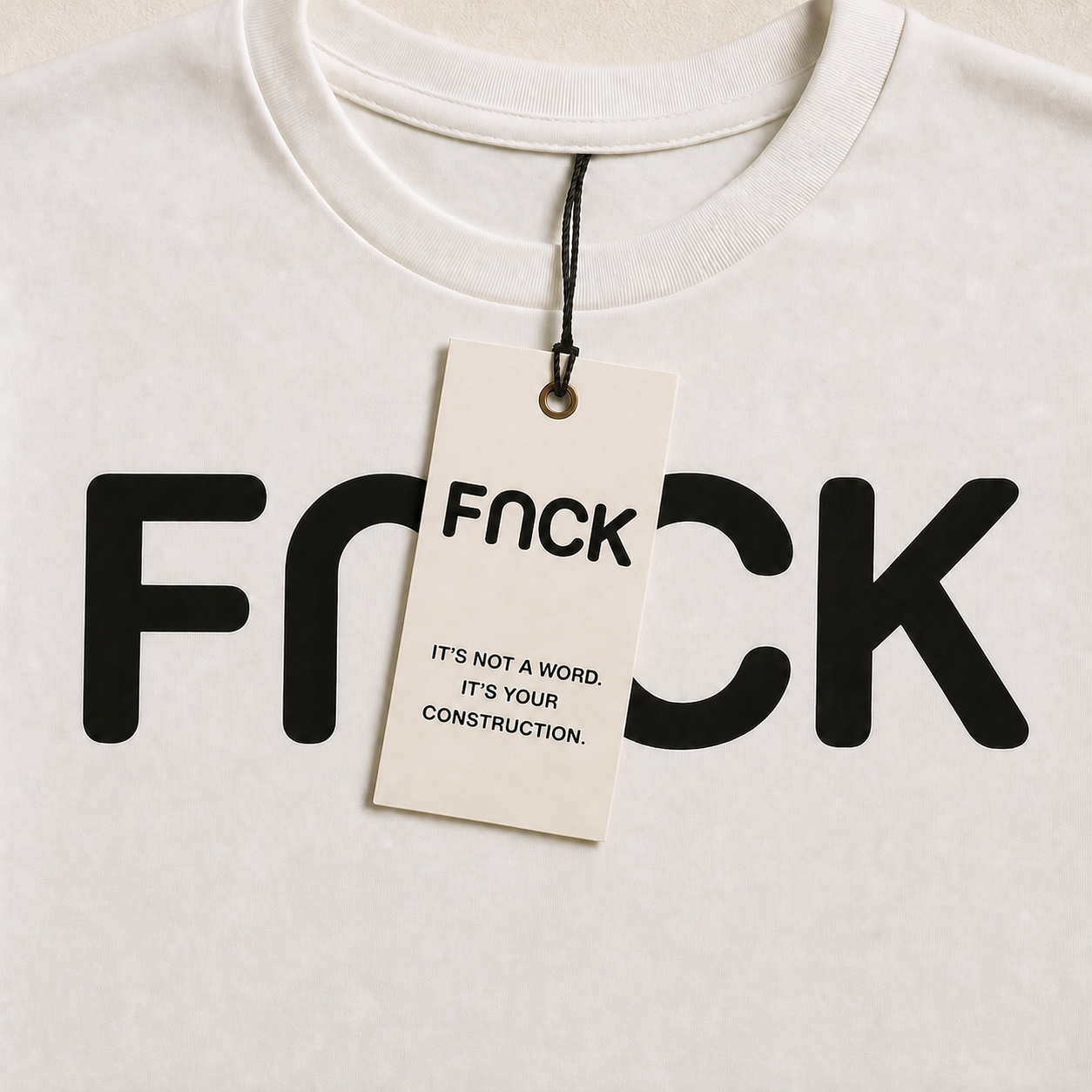 Close-up of a white FNCK shirt and message tag